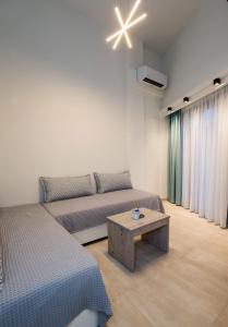 a living room with two beds and a coffee table at Mr & Mrs K Lofts in Potos