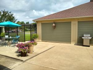 a garage with a table and an umbrella at Southern Comfort Suites in Mayfield