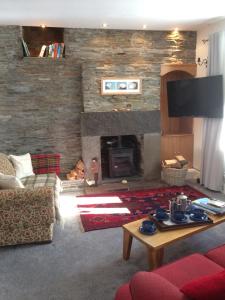 a living room with a couch and a fireplace at Lower Thura House in Wick