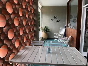 a table and chairs on a patio with a wooden wall at Camogli - "La Porta Rossa" - Liguria Holidays in Sori