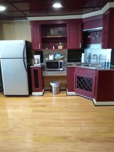 a kitchen with purple cabinets and a white refrigerator at Southern Comfort Suites in Mayfield