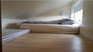 A bed or beds in a room at Vatnsás 10