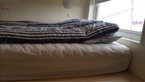 A bed or beds in a room at Vatnsás 10
