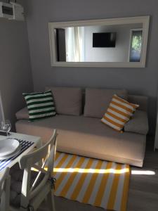 a living room with a couch and a table at Apartamenty Przystań in Międzyzdroje