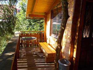 a porch of a house with a bench and a window at Baumhaus Wolfshöhle in Fischach