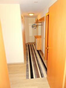 a hallway with a room with a closet and a door at Appartement Christine in Grossarl