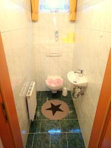 a bathroom with a toilet and a sink at Appartement Christine in Grossarl