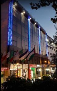 a building with blue lights on the side of it at Al Mansi hotel in Amman