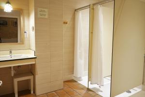 a bathroom with a shower and a sink at Hostel Menorca in Ciutadella