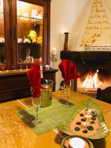 a table with a plate of food and a fireplace at Holiday Home La Casetta delle Candele in Montemerano