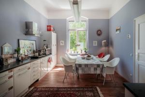 a kitchen with a table and chairs and a window at Casa Hostel Pirna in Pirna