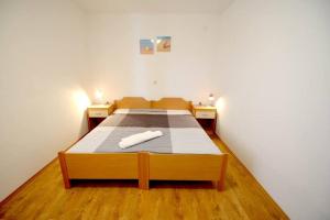 Postel nebo postele na pokoji v ubytování Apartmani Luka