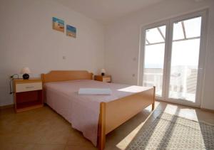 Postel nebo postele na pokoji v ubytování Apartmani Luka