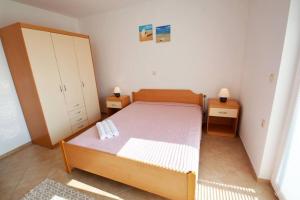 Postel nebo postele na pokoji v ubytování Apartmani Luka