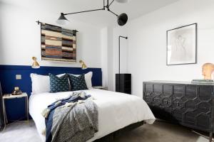 a bedroom with blue and white walls and a bed at Sonder Edgware Road in London