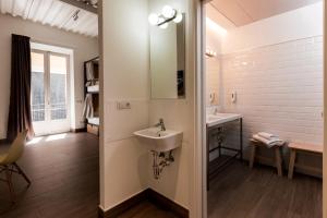 a bathroom with a sink and a mirror at Nut Hostel in Granada +25 photos