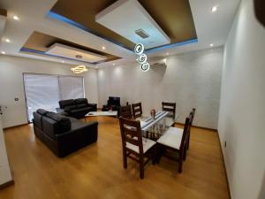 a living room with a glass table and a couch at Apto Duarte T2 in Praia