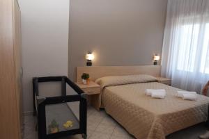 Postel nebo postele na pokoji v ubytování Hotel Excelsior