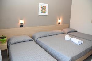 Postel nebo postele na pokoji v ubytování Hotel Excelsior