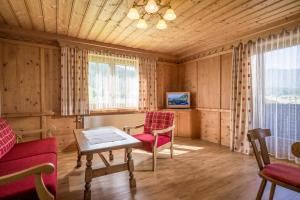 a living room with two chairs and a table at Haus Carolin in Westendorf