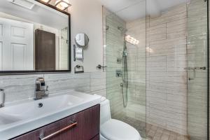 a bathroom with a sink and a glass shower at Diana's Luxury Bed and Breakfast in Vancouver +93 photos