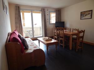 a living room with a couch and a table at Chevêche in Germ