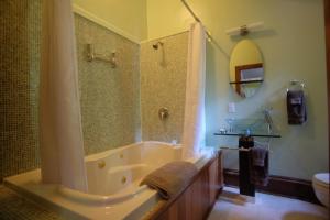 a bathroom with a tub and a shower and a sink at Wedgwood Manor and Glamping Retreat in Crawford Bay +37 photos