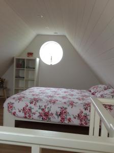 Un dormitorio con una cama con flores. en Vakantiewoning Het Gemaal, en Oostwold