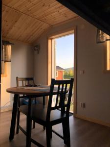 a dining room with a table and chairs and a window at Sörmarks Camping in Sörmark