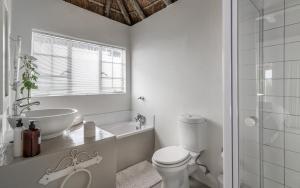 a white bathroom with a sink and a toilet at Green Park Manor in Johannesburg