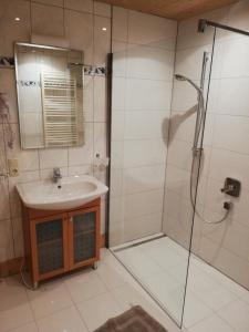 a bathroom with a sink and a shower at Ferienwohnung Klammhof in Zell am Ziller