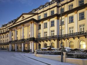 a large yellow building with columns on a street at Crown Spa Hotel Scarborough by Compass Hospitality in Scarborough