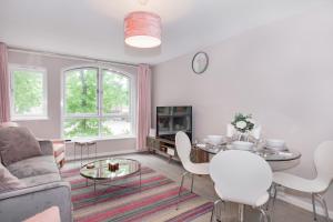 a living room with a couch and a table at Gloucester Green Suite in Oxford