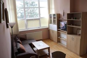 a living room with a couch and a tv at Apartmán Lux Prešov in Prešov