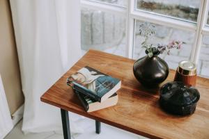 einen Tisch mit einem Buch und einer Vase darauf in der Unterkunft Die Backstube in Traben-Trarbach