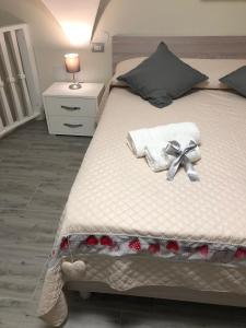 a bedroom with a bed with a bow on it at LA CASA DI NANA' in Naples