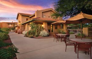 a patio with tables and chairs in front of a house at WorldMark Rancho Vistoso in Oro Valley