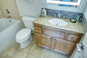 a bathroom with a white toilet and a sink at Desert Rose Resort in Las Vegas