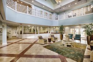 a large living room with a staircase and a lobby at Club Wyndham Cypress Palms in Kissimmee