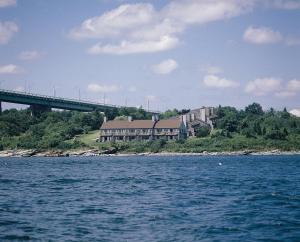 a house on the shore of a body of water with a bridge at Club Wyndham Newport Overlook in Jamestown