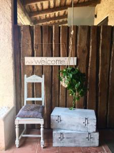een stoel en een bord dat zegt welkom en een plant bij CASA LAURA Garda lago in Pozzolengo