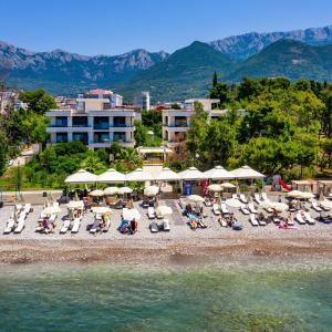 a group of chairs and umbrellas on a beach at Apartments Kuce Lekovica Beach & snack bar- Bistro in Bar