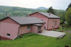 a couple of pink houses on a hill at Villa Žakýl in Banská Štiavnica