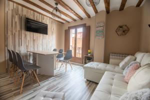 a living room with a white couch and a table at Los señoritos in Haro