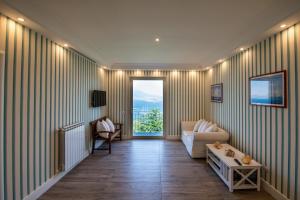 a living room with a couch and a window at Le Fratte Luxury Home in Castellammare di Stabia