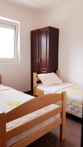 Postel nebo postele na pokoji v ubytování Apartmani Lazarevic