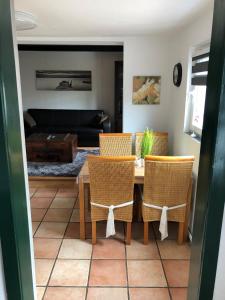 a living room with a table and chairs and a couch at Großer Hookie in Hooksiel