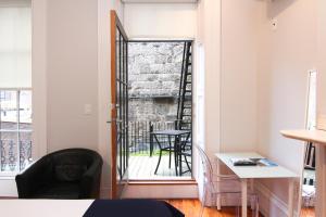 a room with a door to a balcony with a table at Comfy Beacon Hill Studio Great for Work Travel #7 in Boston