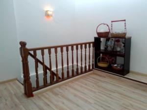 a wooden staircase in a room with a basket on the wall at Happy Sweet Heritage Residence Malacca Jonker Walk in Melaka