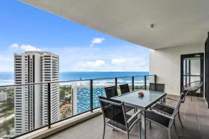 a balcony with a table and chairs and the ocean at Sierra Grand Broadbeach - GCLR in Gold Coast